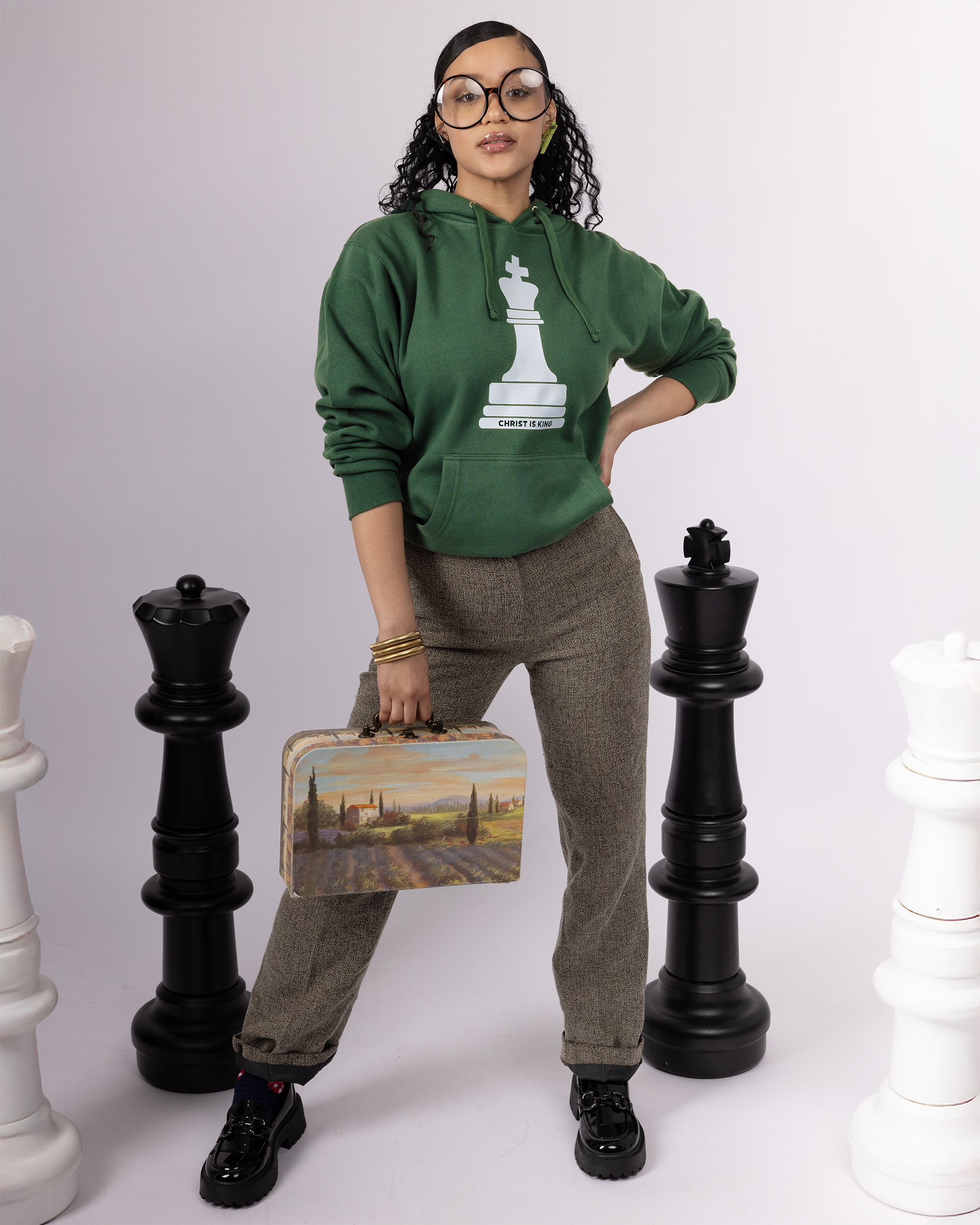 Faith-inspired Christ is King hoodie in green, heavyweight cotton blend with screen printed king chess piece symbolizing Revelation 19:16